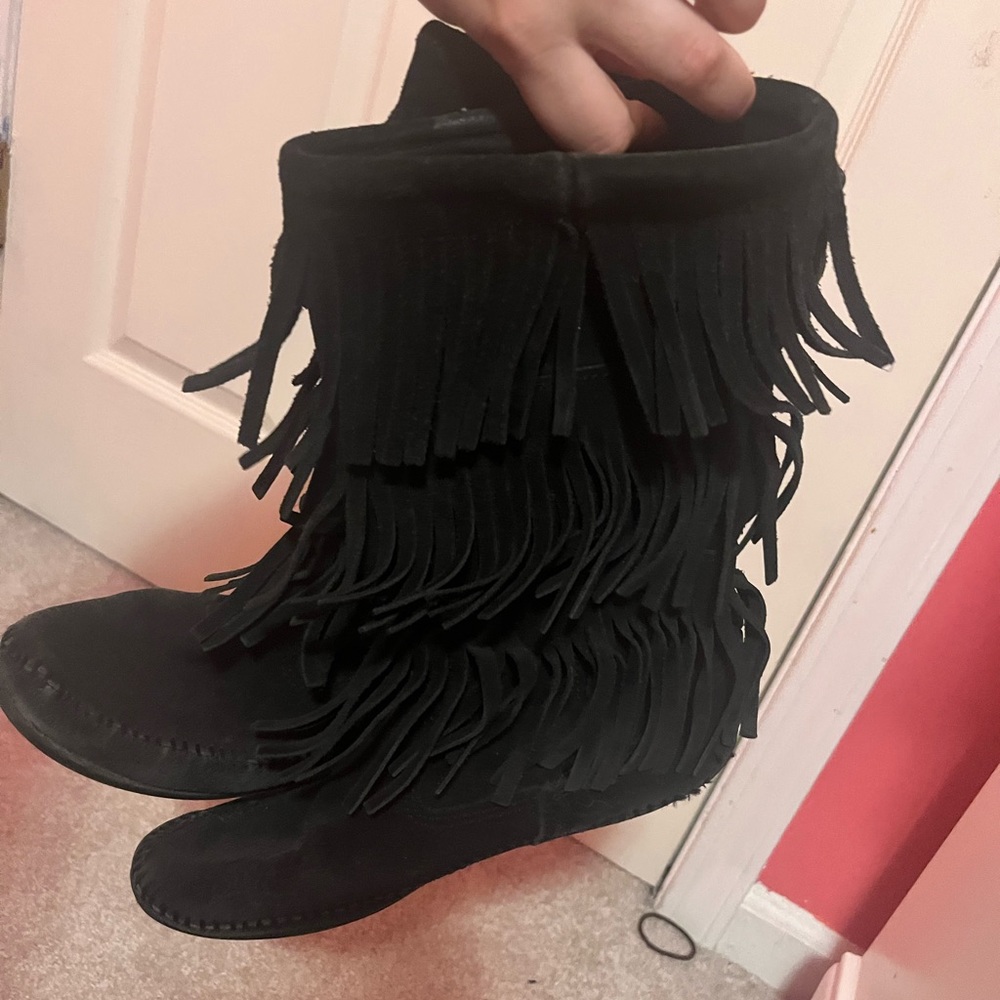 Black Minnetonka moccasins. Worn through the years! Still in good condition.